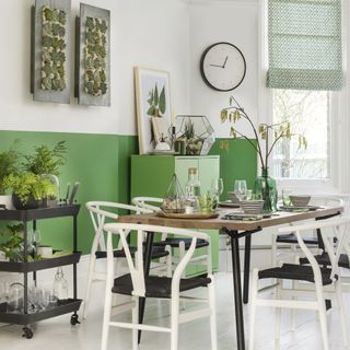 dining room with half painted green walls