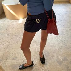 Woman in shorts and ballet flats