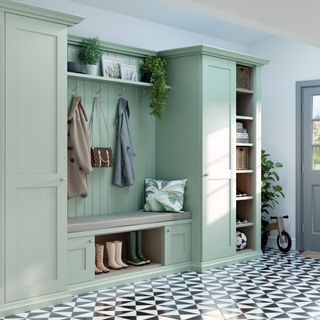 Neville Johnson green boot room storage solution for a hallway, with tiled floor and a grey door to the right