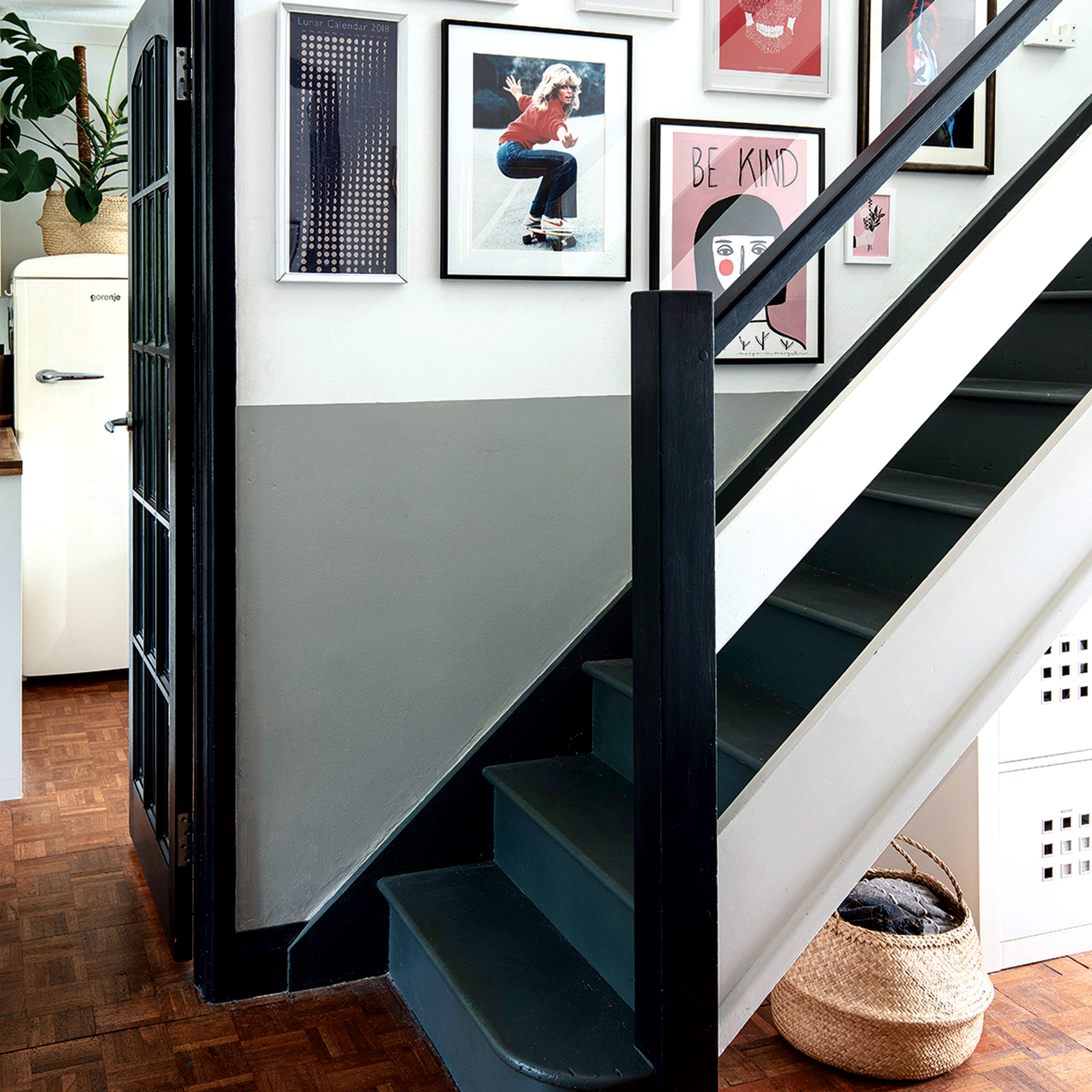 Black stair case with gallery wall