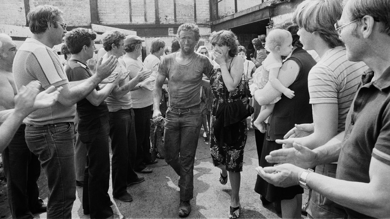 A coal miner is greeted by his wife after a brief occupation of the pit during the miners&#039; strike