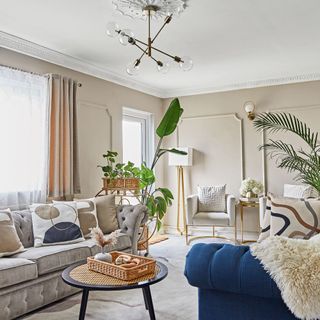 Living rom with pale grey and blue sofas and neutral colour scheme