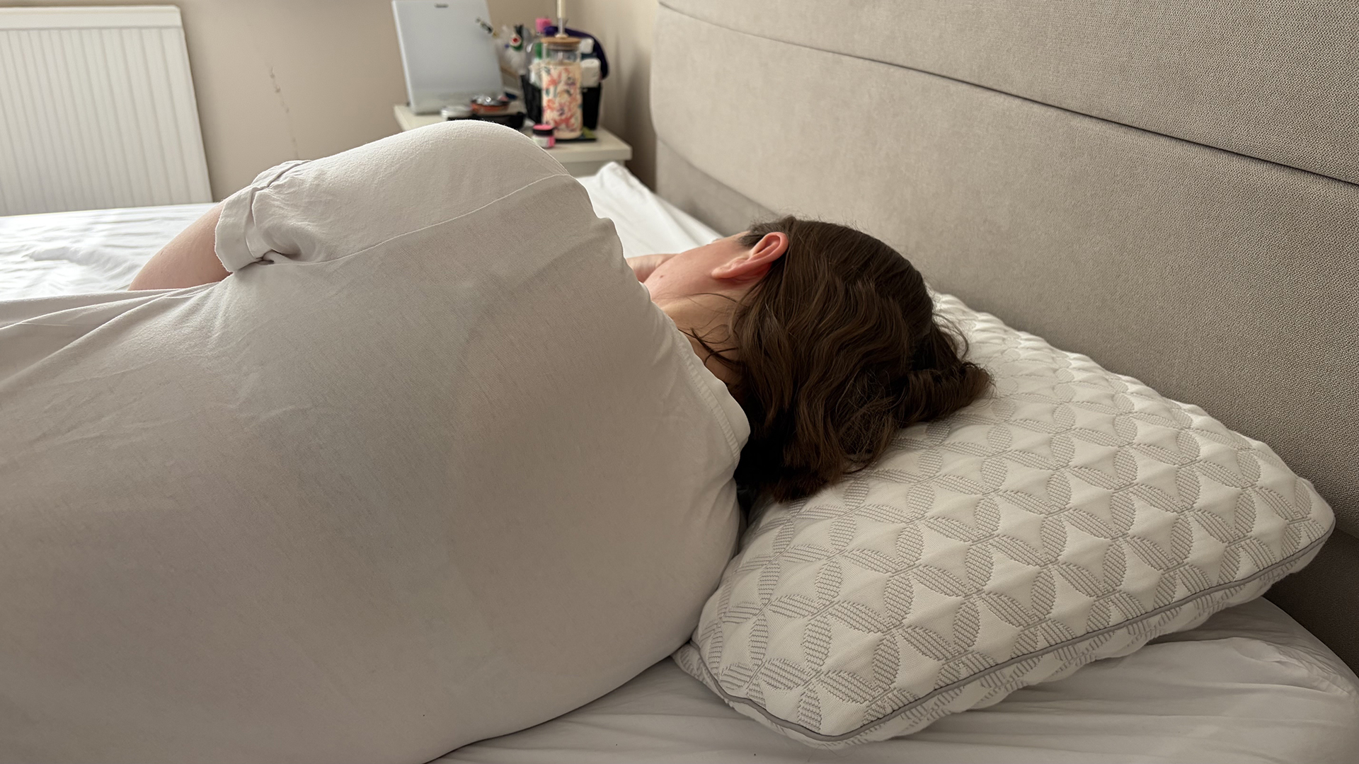 Pillow tester Ruth Jones lies on her side with her head resting on the Helix Talalay Latex pillow