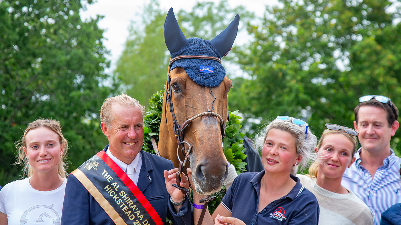 Hickstead Derby winner William Funnell stand beside his horse Dublon with members of his Billy Stud team