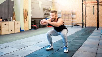 Man holding a squat