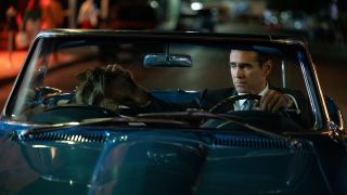 John Sugar (Colin Farell), petting a dog while driving a convertible car in "Sugar"