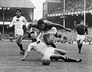 Portugal's Eusebio is brought down and wins a penalty against North Korea at the 1966 World Cup.