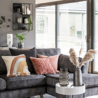 Grey living with a sofa and french doors