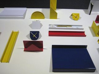 Multiple objects of different shapes and colours, displayed on a white surface