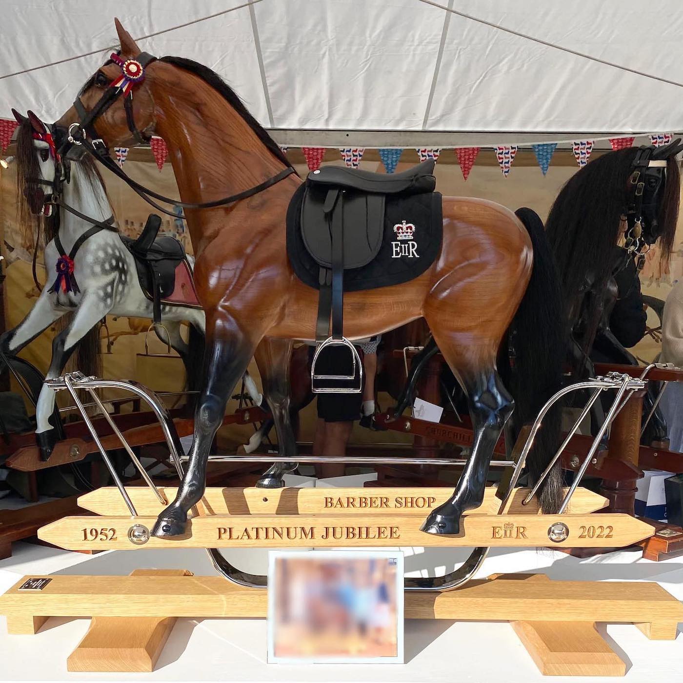 A rocking horse replica of Barbers Shop has been presented to The Queen