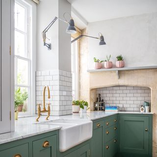 fireclay belfast sink in green shaker kitchen with subway tiles