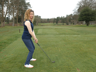 Golf Monthly Top 50 Coach Katie Dawkins demonstrating a posture that is too tall for the golf swing