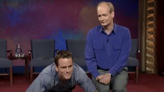 Chip catching a wave of his surfboard next to Colin on Whose Line Is It Anyway?