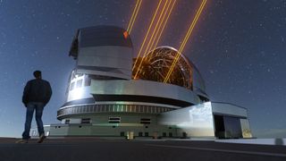 The Extremely Large Telescope at twilight with a person standing in the foreground