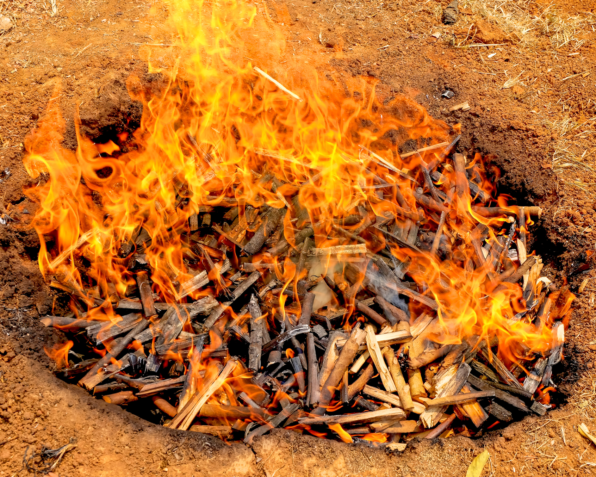 burning biochar in a pit in the ground