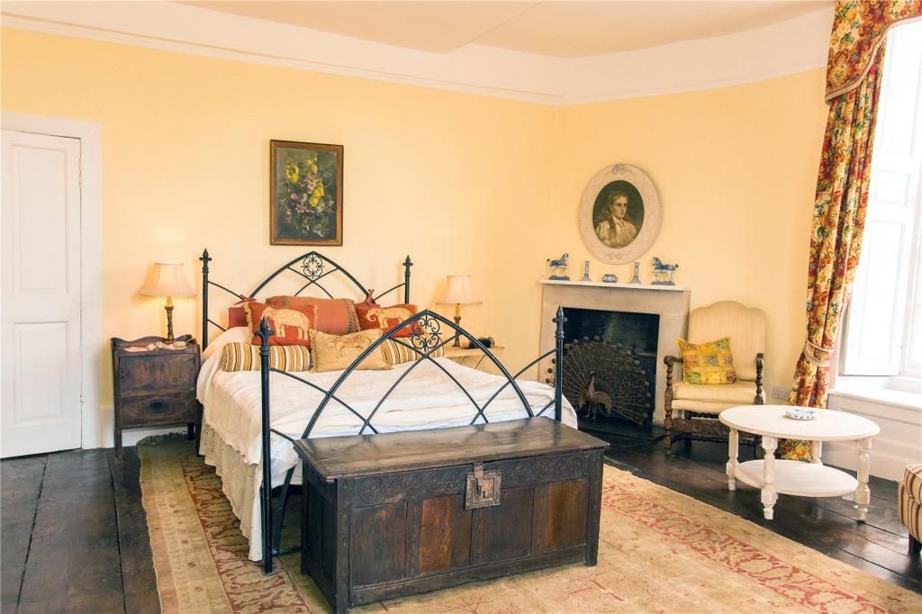 Another bedroom in the property with wrought iron double bed and yellow walls
