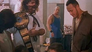 Dwayne Johnson, as The Rock, backstage at a WWF show with Mankind and Stone Cold Steve Austin