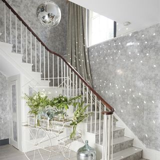 hallway with greys and whites staircase and disco ball