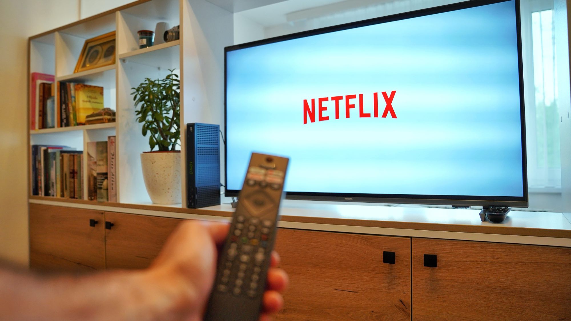 Netflix logo on TV with remote control in the foreground