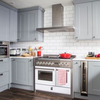 Gray kitchen cabinets with oven and extractor fan