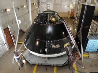 NASA's Orion capsule, shown here being assembled and tested at Lockheed Martin's Vertical Testing Facility in Colorado, has room for four crewmembers. 