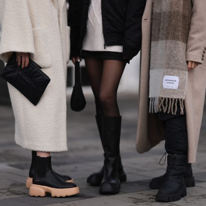Annabel Rosendahl (L) is seen wearing Copenhagen Studios CPH 276 Vitello black/ pale beige boots, Copenhagen Studios black clutch bag and Dorothee Schumacher creme white wool coat; Marie Hindkaer (M) is seen wearing a black Prada nylon bag, black leather Copenhagen Studios CPH145 boots, creme white Samsoe Samsoe knit sweater, Acne Studios black short skirt and a black Jw Anderson x Uniqlo jacket; Mie Juel (R) wears Copenhagen Studios beige wool scarf, Copenhagen Studios CPH149 black boots, Birgitte Herskind beige wool coat and black Basic Apparel pants, on November 15, 2022 in Reykjavik, Iceland. (Photo by Jeremy Moeller/Getty Images for Copenhagen Studios)