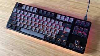 Drop CTRL V2 keyboard on a wooden desk with RGB lighting on