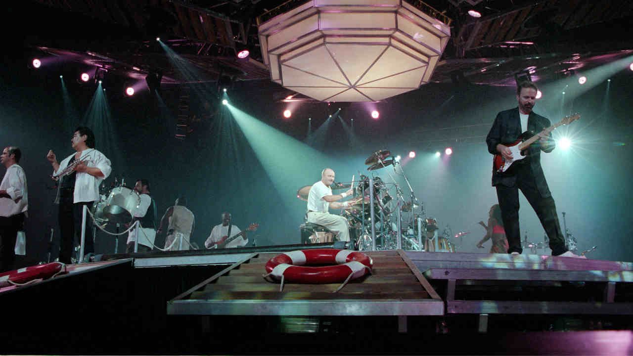 Phil Collins and his solo band performing live in 1997