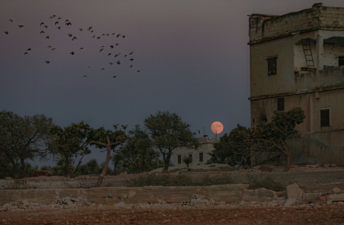 The Sturgeon Moon appears over Idlib, Syria on Aug. 21, 2021.