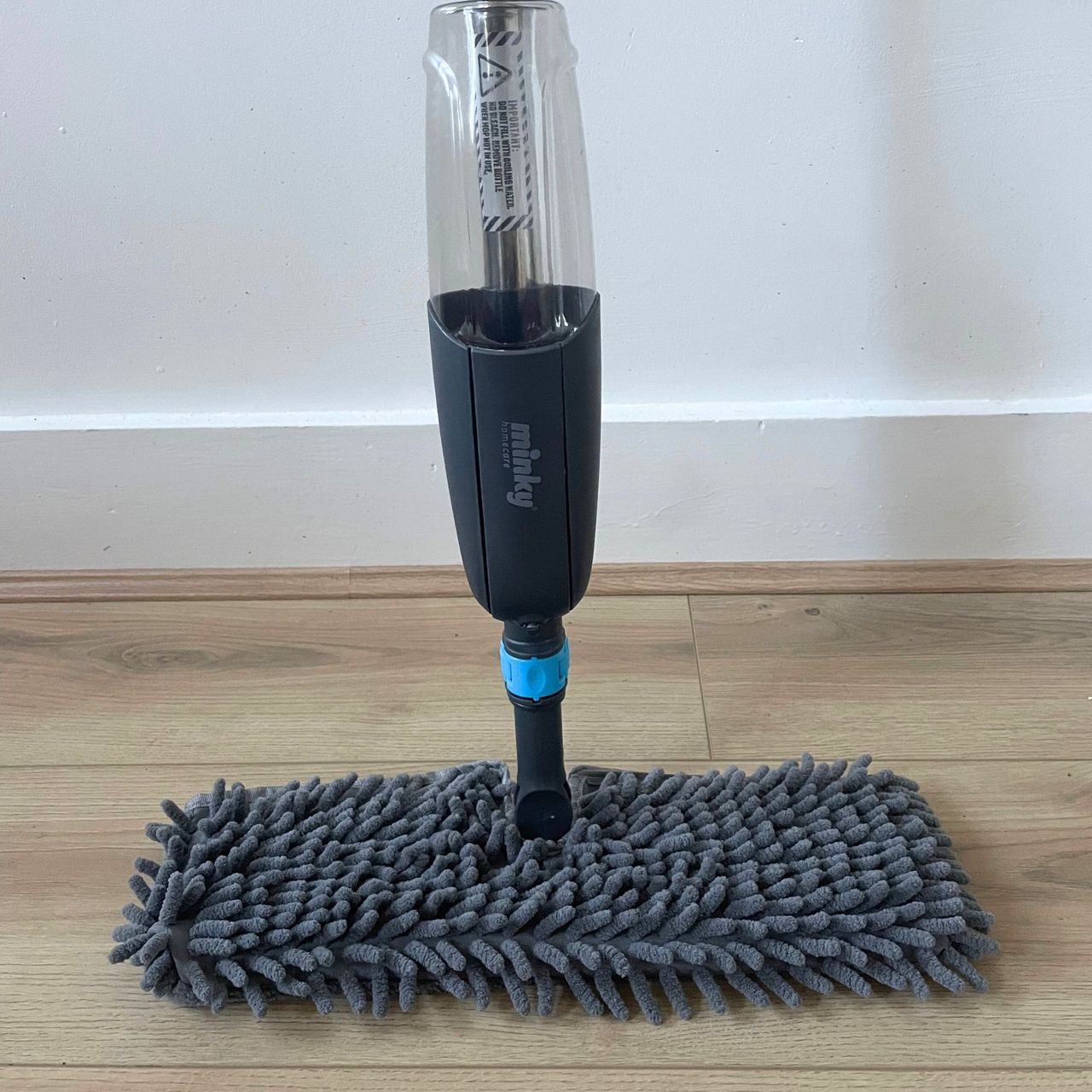 Minky Flexi Spray Mop standing on wood-effect flooring