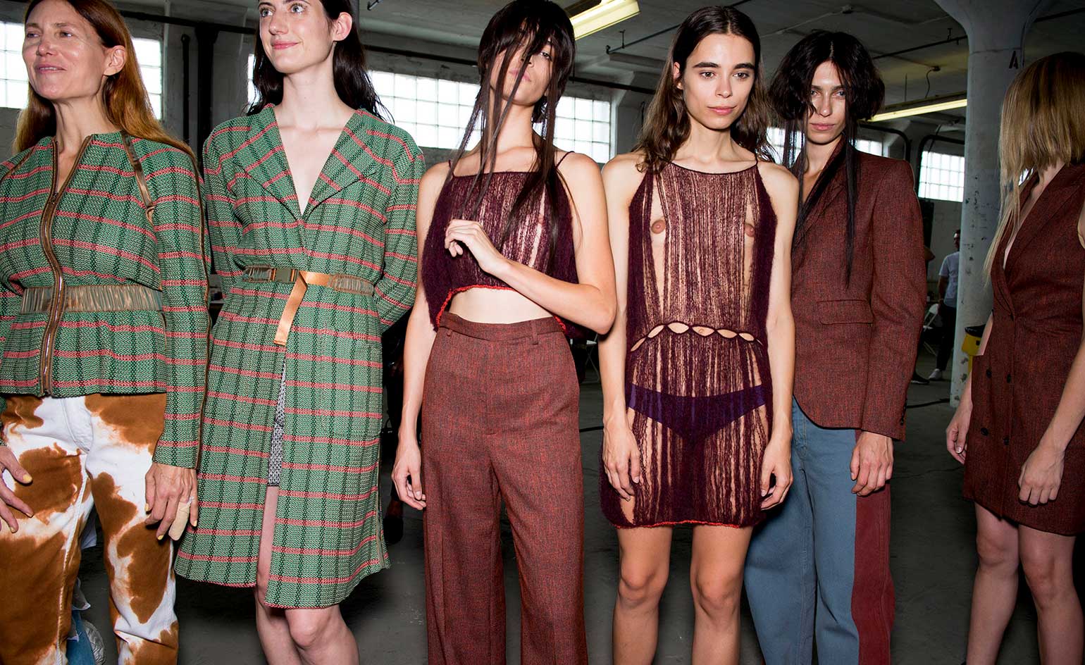 Eckhaus Latta S/S 2019 models dressed in autumnal coats and transparent dresses