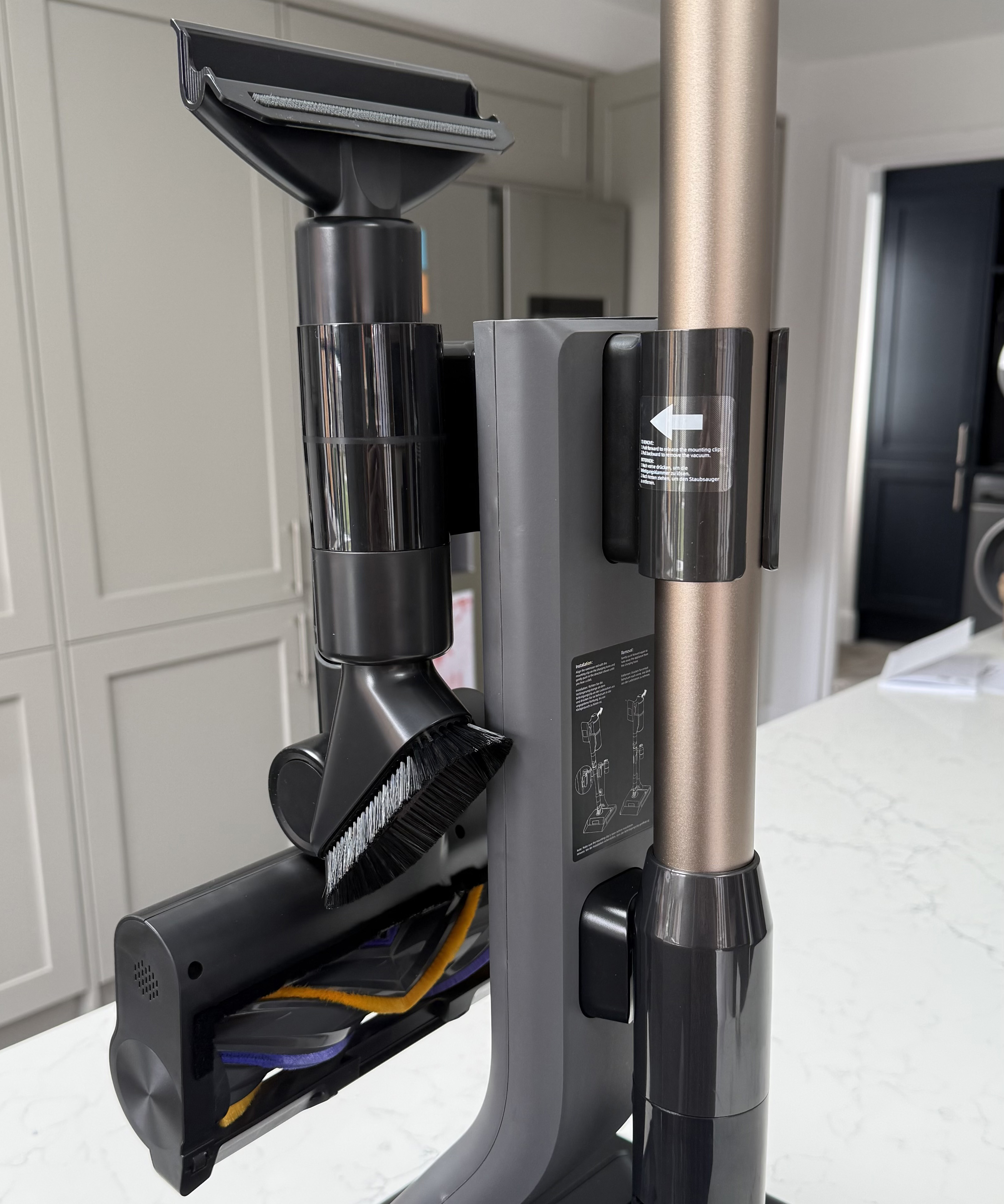 Dreame Z30 Pro Aqua vacuum dock holding multiple cleaning attachments including a crevice tool and dusting brush