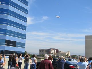 Space shuttle Endeavour and its carrier aircraft fly over the UC Irvine Medical Center in Irvine, Calif., on Sept. 21, 2012, while en route to Los Angeles International Airport.