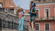 A couple and two young children on a street in Lisbon, Portugal.