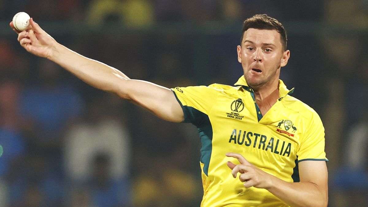 Josh Hazlewood hold a white cricket ball ahead of the England v Australia live stream at the Cricket World Cup 2023.