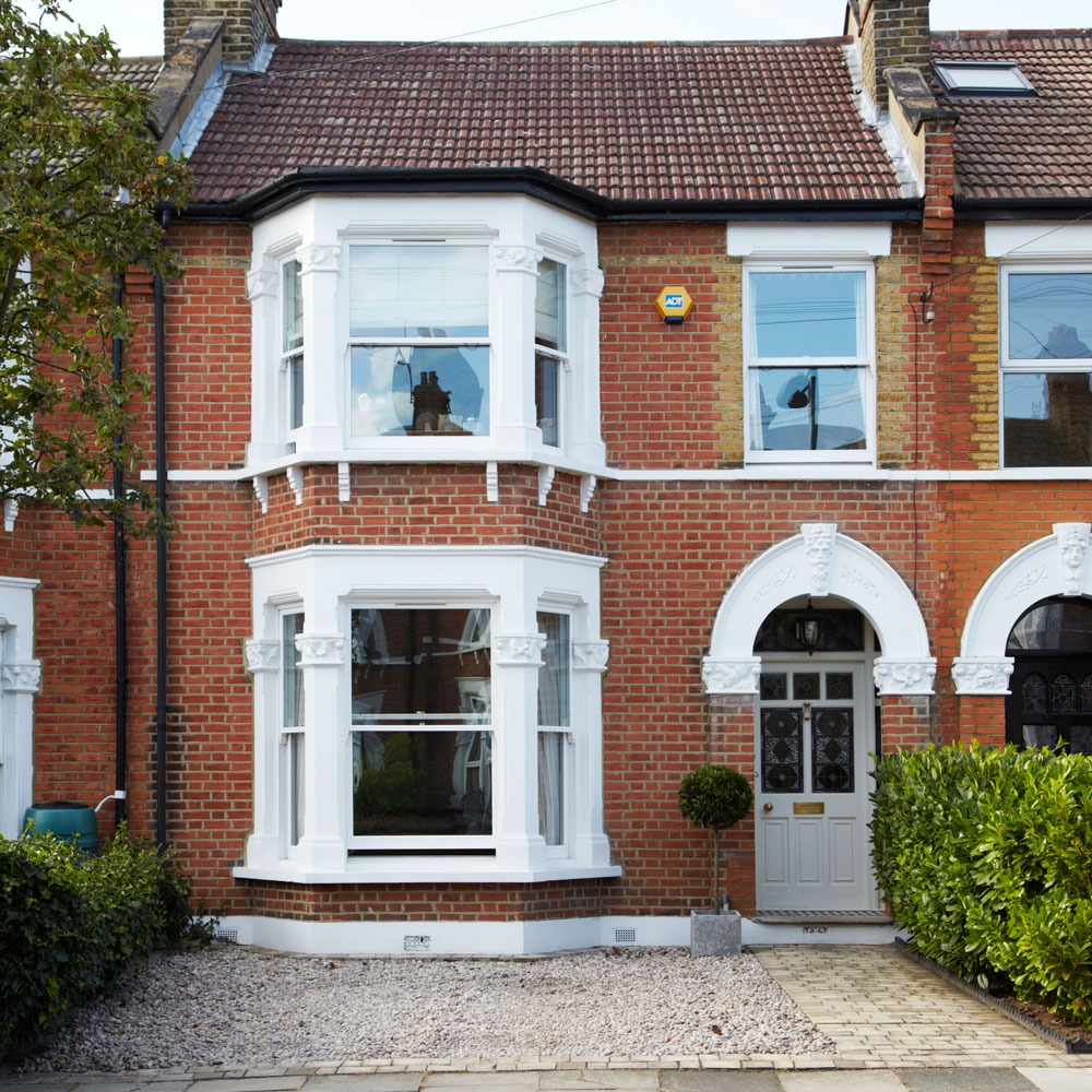 house exterior with white windows and garden