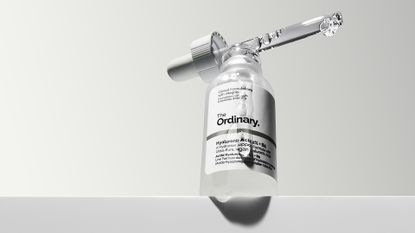 The Ordinary Hyaluronic Acid shot from below with product running down the side of the bottle