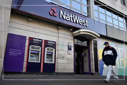 The front of a NatWest bank branch with a person walking past