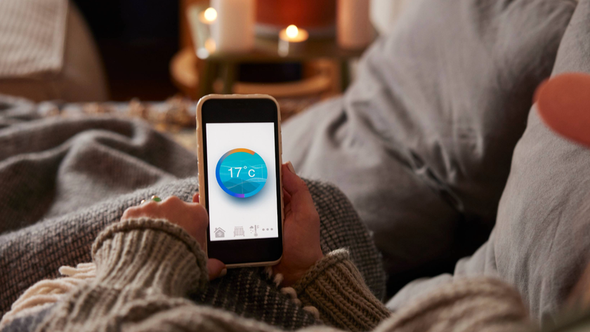 Person&#039;s hands holding a phone with temperature display 