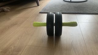 GoFit Super Ab Wheel being tested on wooden floor