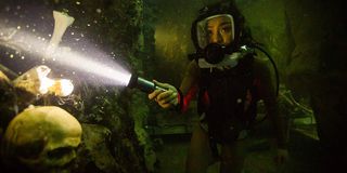 47 Meters Down: Uncaged a diver shining her light on some skeletal debris