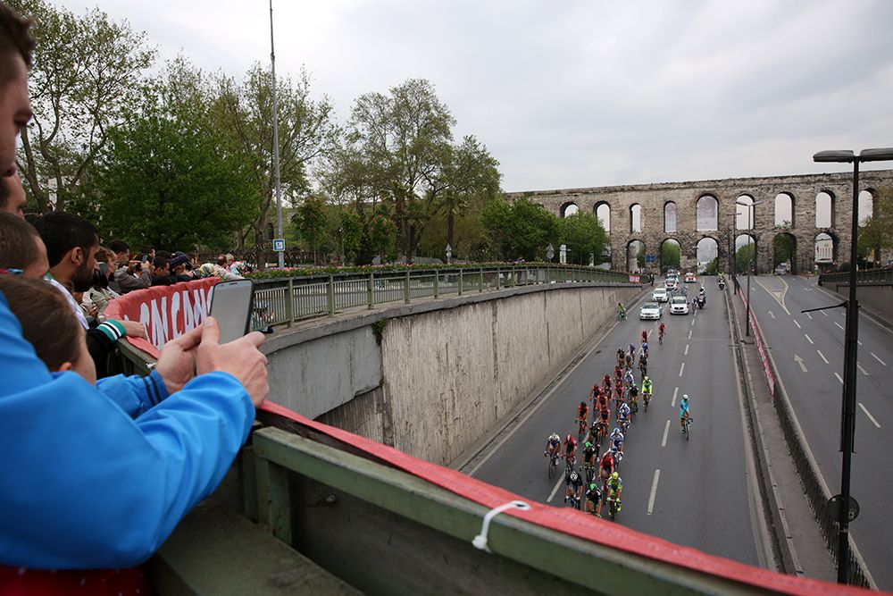 A fan gets into a prime position to watch the race come past