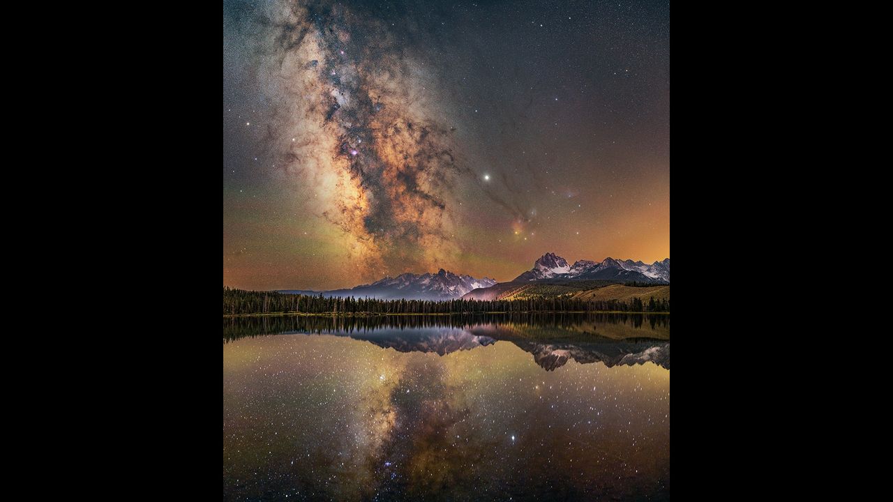 Years ago, before over-fishing, Little Redfish Lake was called as such due to the vast numbers of salmon turning the lake a red color. The red coloration is no longer seen because of salmon, but the color of sunsets and airglow during the night still turn the waters a vibrant red. It is these beautiful warm echoes of red, combined with the mirror-like reflections of the Sawtooth Mountains in the distance and the alignment of the Milky Way with the mountains that make Little Redfish Lake one of the most spectacular places the photographer has ever shot at night. The photographer recalls that &lsquo;we were fortunate enough that night to have the lakeshore to ourselves, just three of us, and a rather excited dog who tried his best not to run into our tripods! We spent the sunset here, waiting for the stars to come out and the Milky Way core to rise, marveling at the red color of the water.&rsquo;