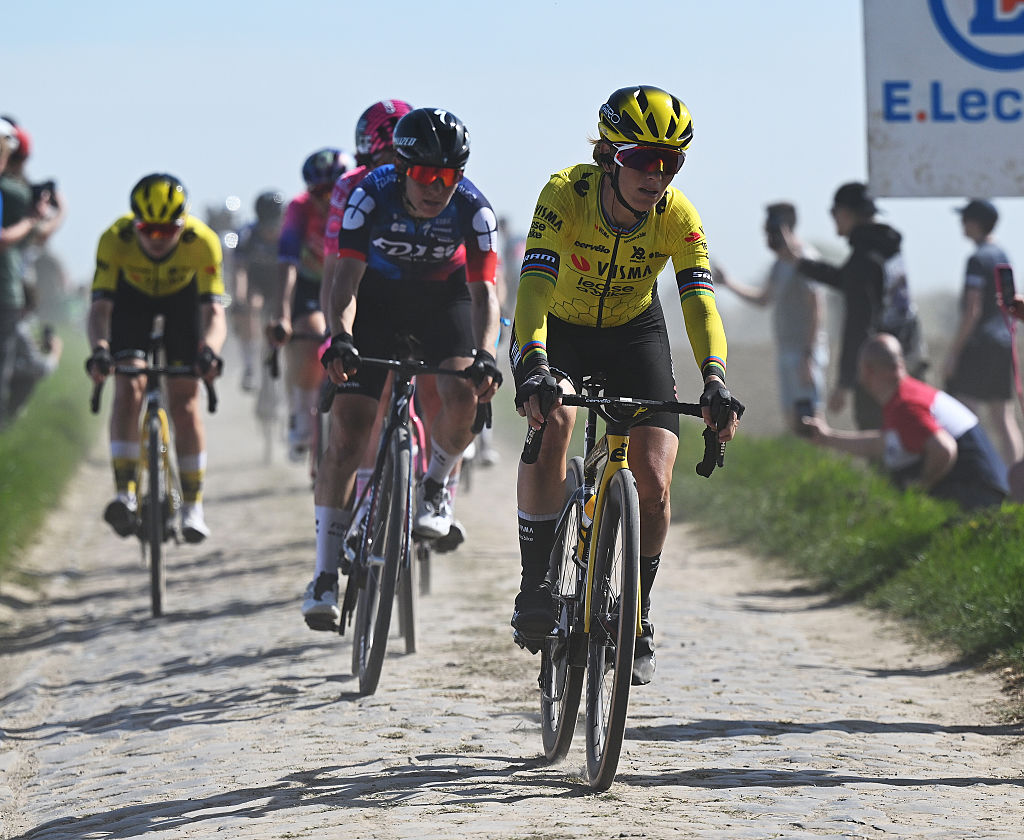 The elite women's peloton, Pauline Ferrand-Prevot, racing on a sunny day at the 2025 Paris-Roubaix Femmes