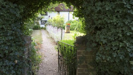 old iron gate leading into a garden