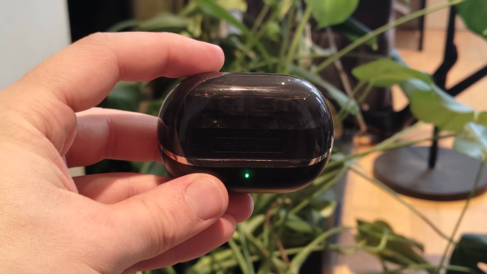 The Soundpeats H3 being held in a man&#039;s hand.