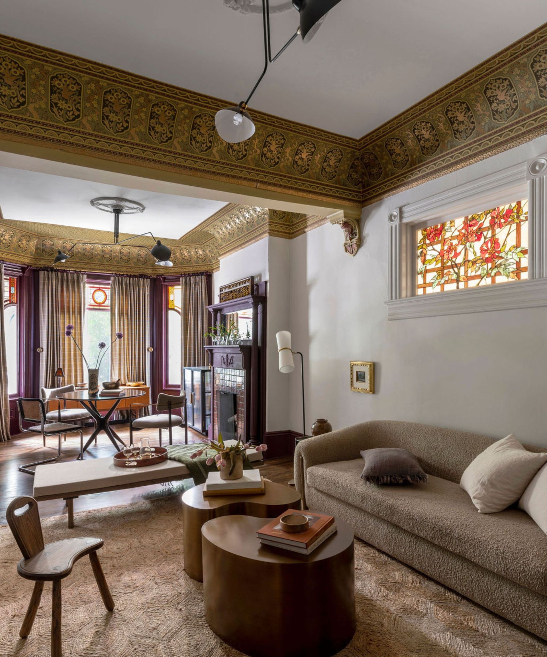 Open plan living room with brown couch and purple accents