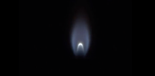A flame burns inside the "combustion science cabinet" aboard the Tiangong space station's Mengtian module.