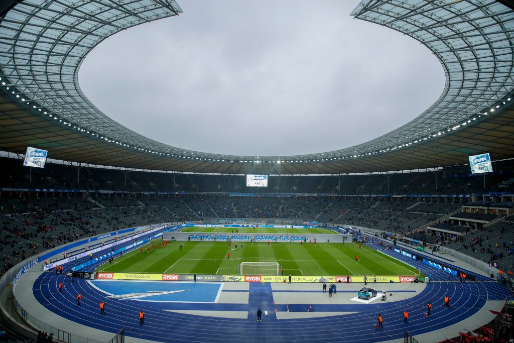 A general view shows the teams warming up on either side of a mock-up of the former Berlin Wall bearing the inscrition &quot;Together gainst Walls, together with Berlin&quot; standing across the pitch before the start of German first division Bundesliga football match Hertha BSC Berlin v RB Leipzig, at the Olymic Stadium in Berlin on November 9, 2019. - Germany celebrates 30 years since the fall of the Berlin Wall ushered in the end of communism and national reunification, as the Western alliance that secured those achievements is increasingly called into question. (Photo by Odd Andersen / AFP) / RESTRICTIONS: DFL REGULATIONS PROHIBIT ANY USE OF PHOTOGRAPHS AS IMAGE SEQUENCES AND/OR QUASI-VIDEO (Photo by ODD ANDERSEN/AFP via Getty Images) Euro 2024 stadiums