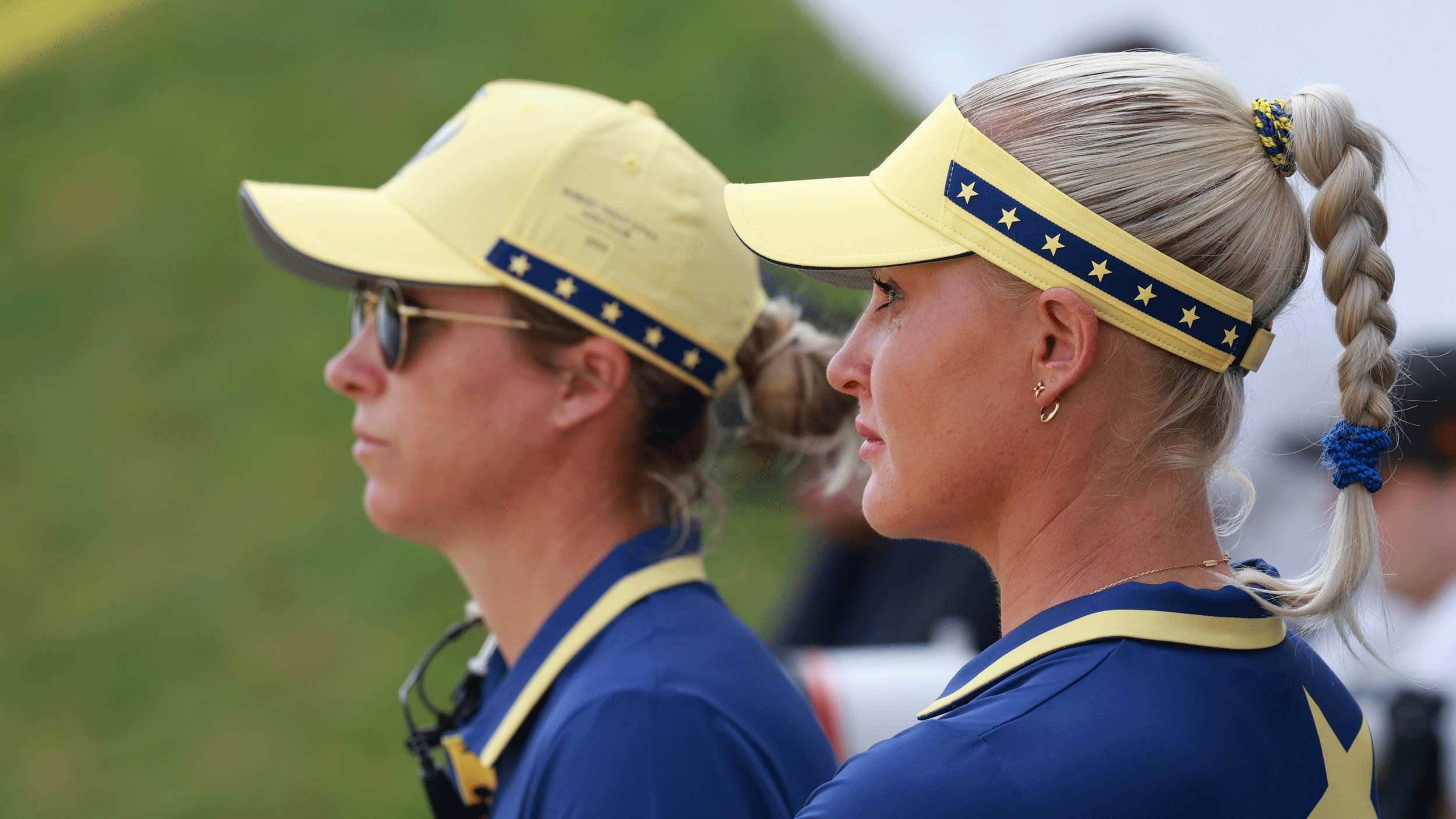 A side profile of Charley Hull (right - foreground) and Mel Reid (left - background) as they look on during the 2024 Solheim Cup